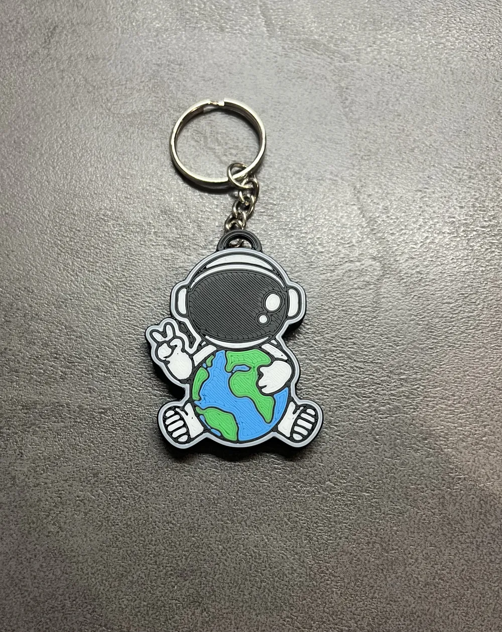 adorable astronaut keychain hugging planet Earth, photo 2 of 4 - adorable astronaut keychain hugging planet Earth Generative Art