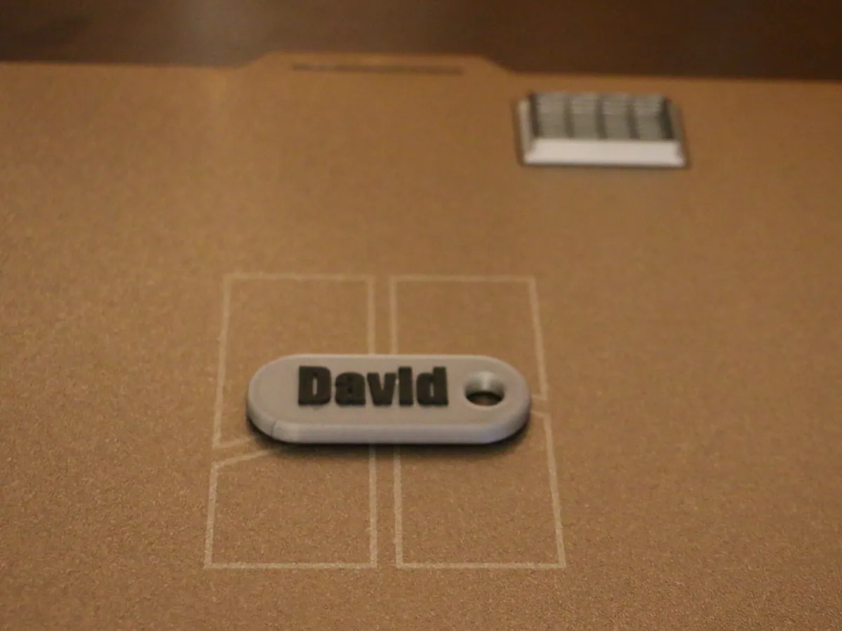 Key chain with double sided text for name