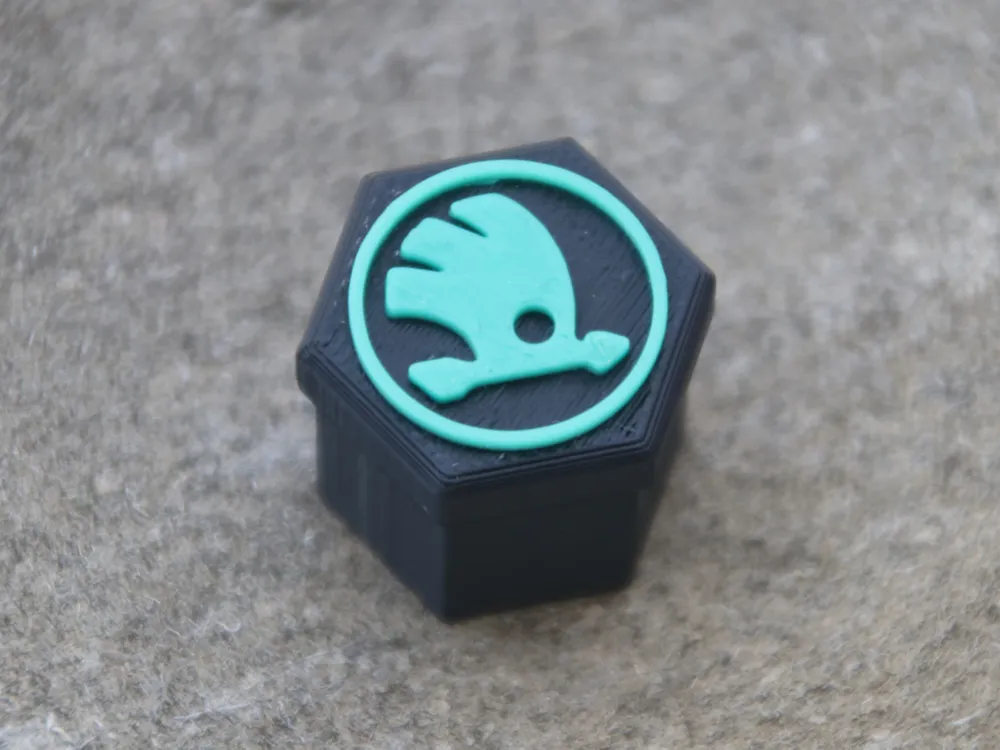 Rim bolt caps with Škoda logo.