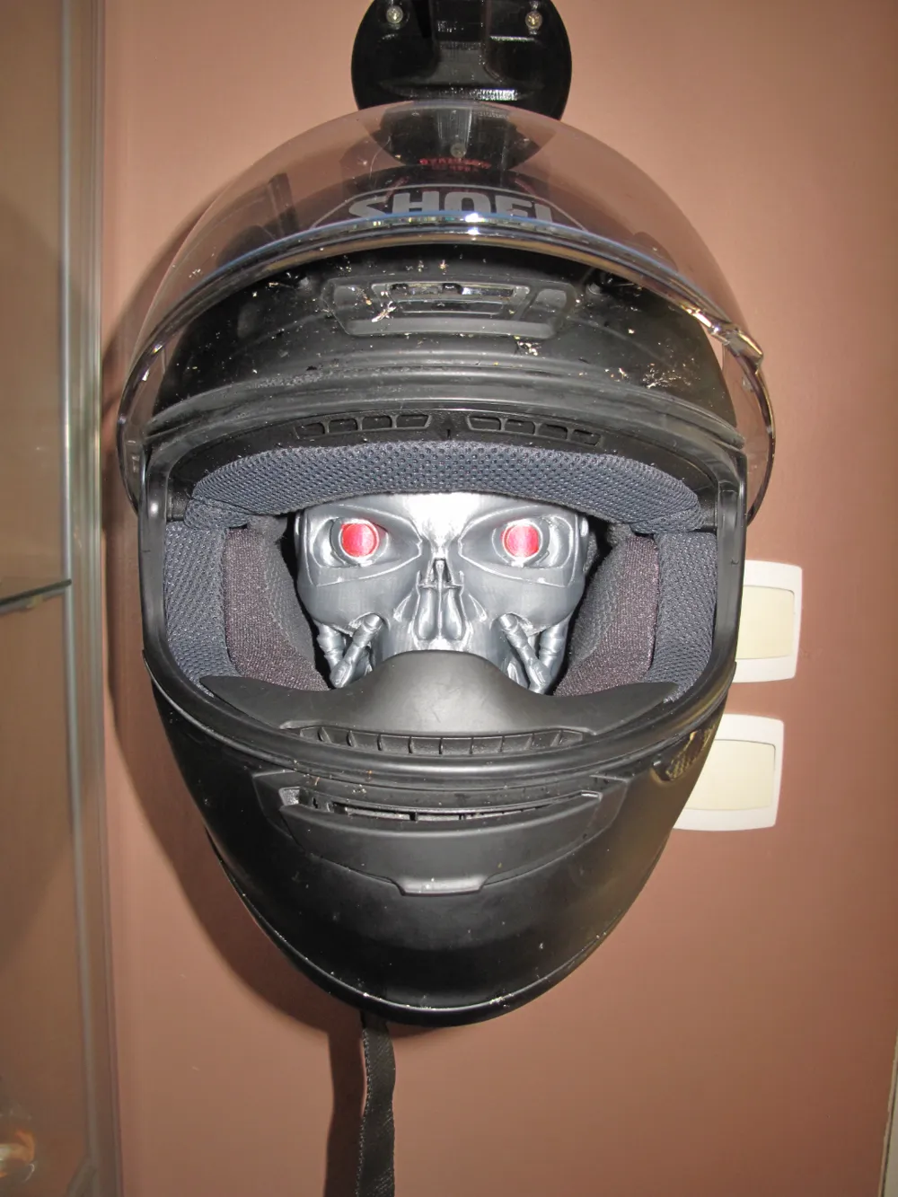 Wall-mounted helmet holder